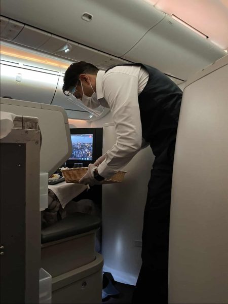 Aeromexico flight attendant serving breadroll Aeromexico Flight Review